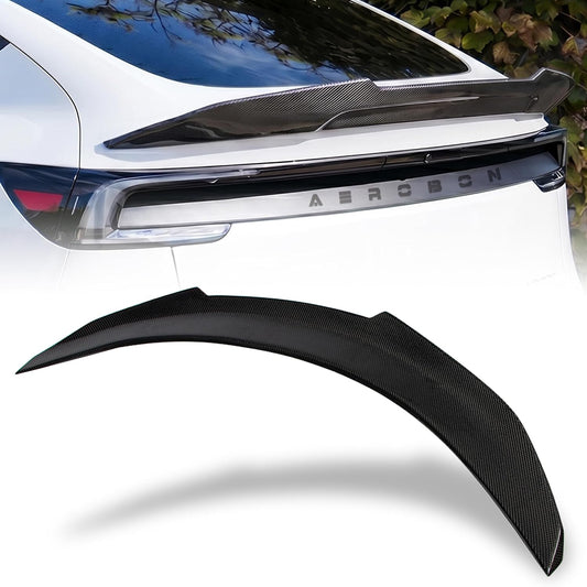 A black carbon fiber rear trunk spoiler shown in two views: one installed on the rear of a white car, and one isolated against a white background.